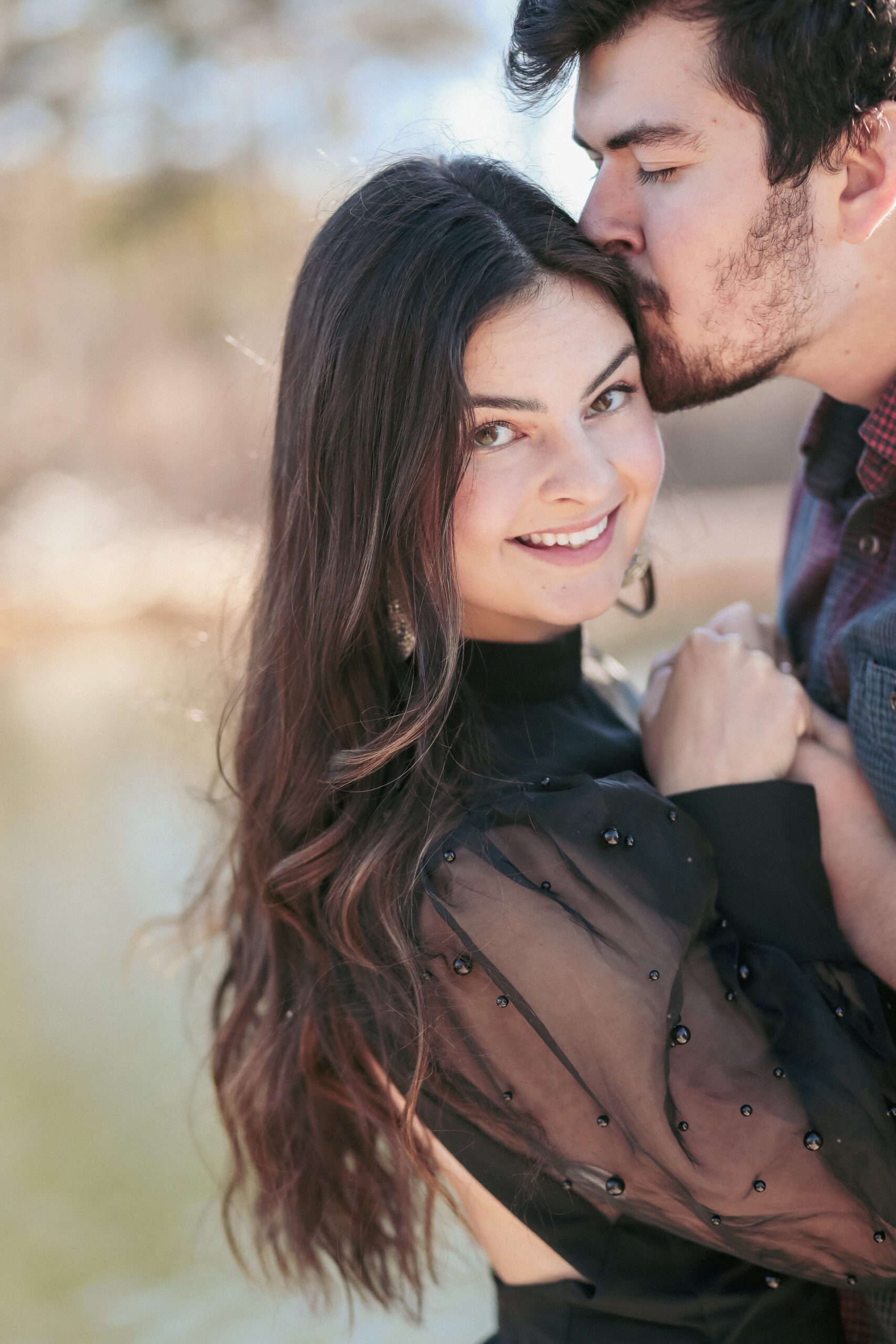 Engaged couple embrace for winter engagement session